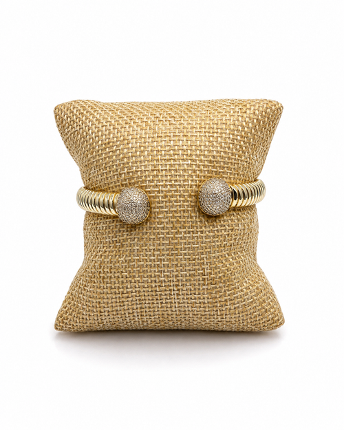 14K gold-filled flexible cuff bracelet set with a row of clear stones, on a white background
