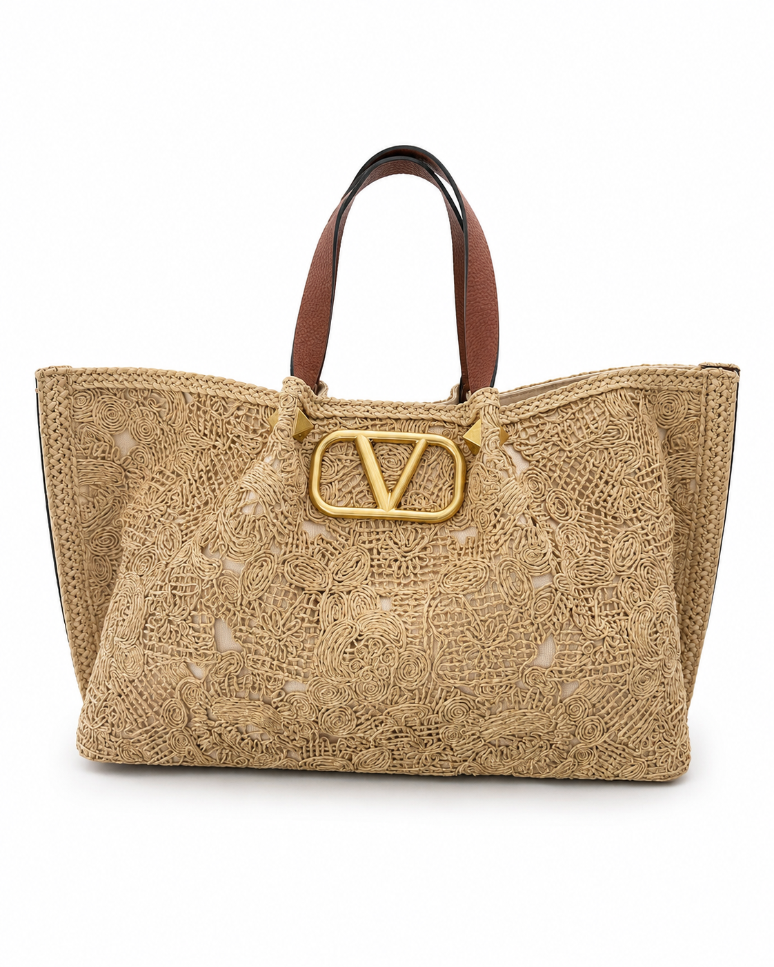A beige woven leather tote bag with brown leather top handles and a prominent gold-tone V logo clasp on the front, photographed against a solid white background.