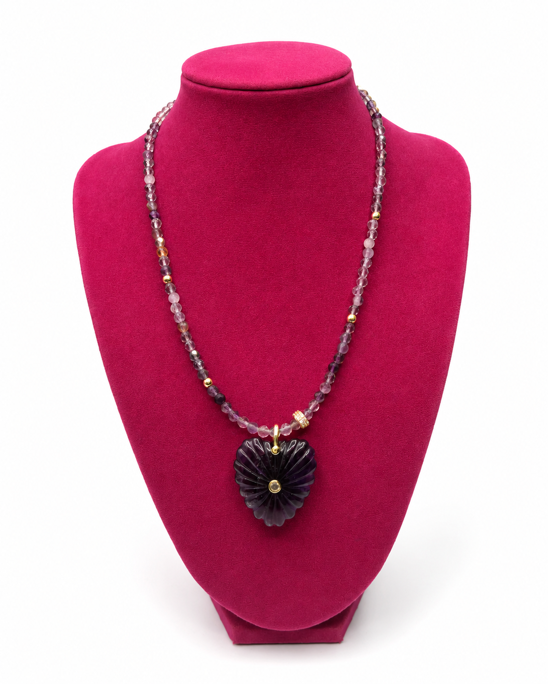 Gold-tone necklace with a smooth purple heart-shaped stone charm and amethyst bead, on a white background